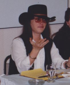 woman wearing cowboy hat sitting at banquet table