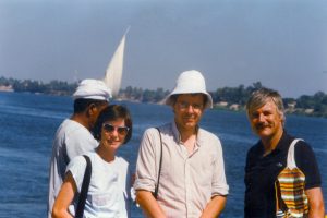 Reville and colleagues standing in sun in front of water