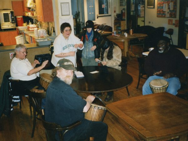 Group of PARC members sitting around a table playing drums