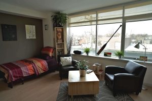 Interior view of apartment in Edmond Place showing bed and living area. This looks like a nice place to live.