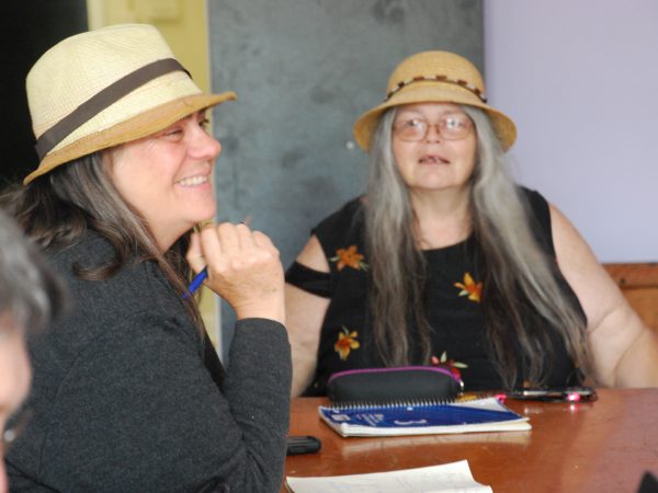 Two women, Lahay and Swainson, sitting at writing table.