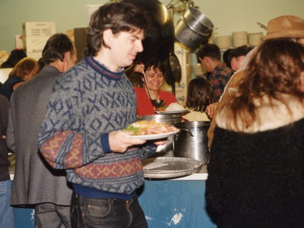 Photo of a crowd of people lined up for shared meal at PARC