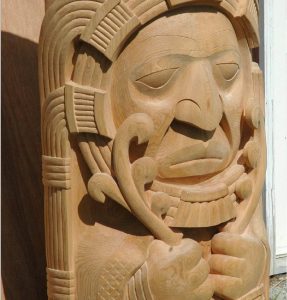 detail from carved wooden totem - face